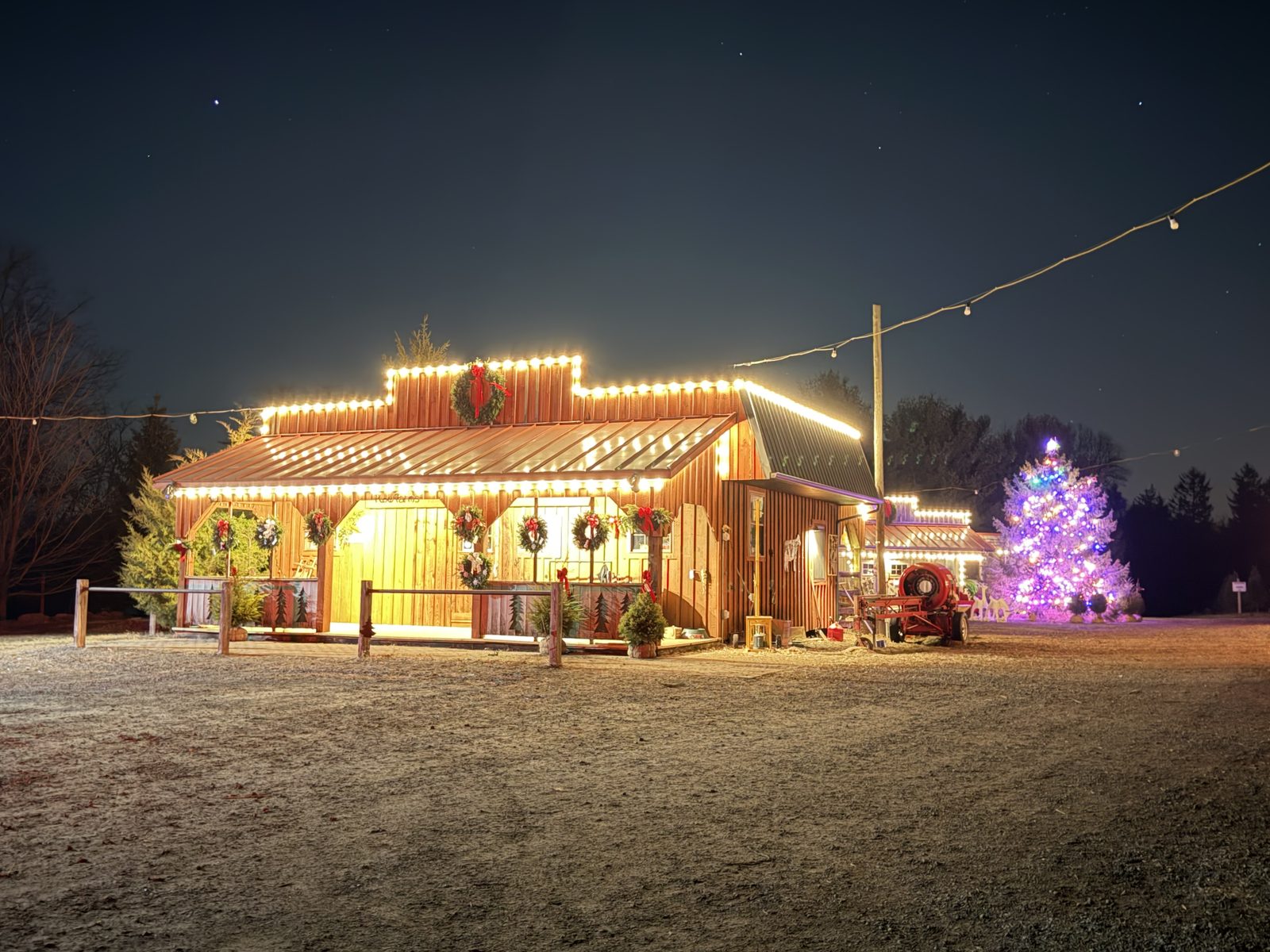 The Plow Farms barn lit up for the holidays at night
